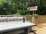 Load image into Gallery viewer, Wooden patio area with a grey wicker sofa bench and glass wicker table with the KMH-3000R 3KW Free Standing Infrared Heater on the deck
