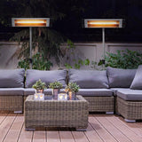 Load image into Gallery viewer, Outside wooden patio area at night with a wicker sofa with grey cushions, accompanying wicker table and two KMH-3000R 3KW Free Standing Infrared Heaters in the background